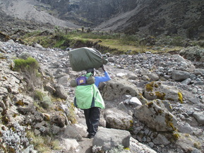 A Kilimanjaro porter, the heroes of every Kilimanjaro trek. Climb Kilimanjaro with Samba Treks.